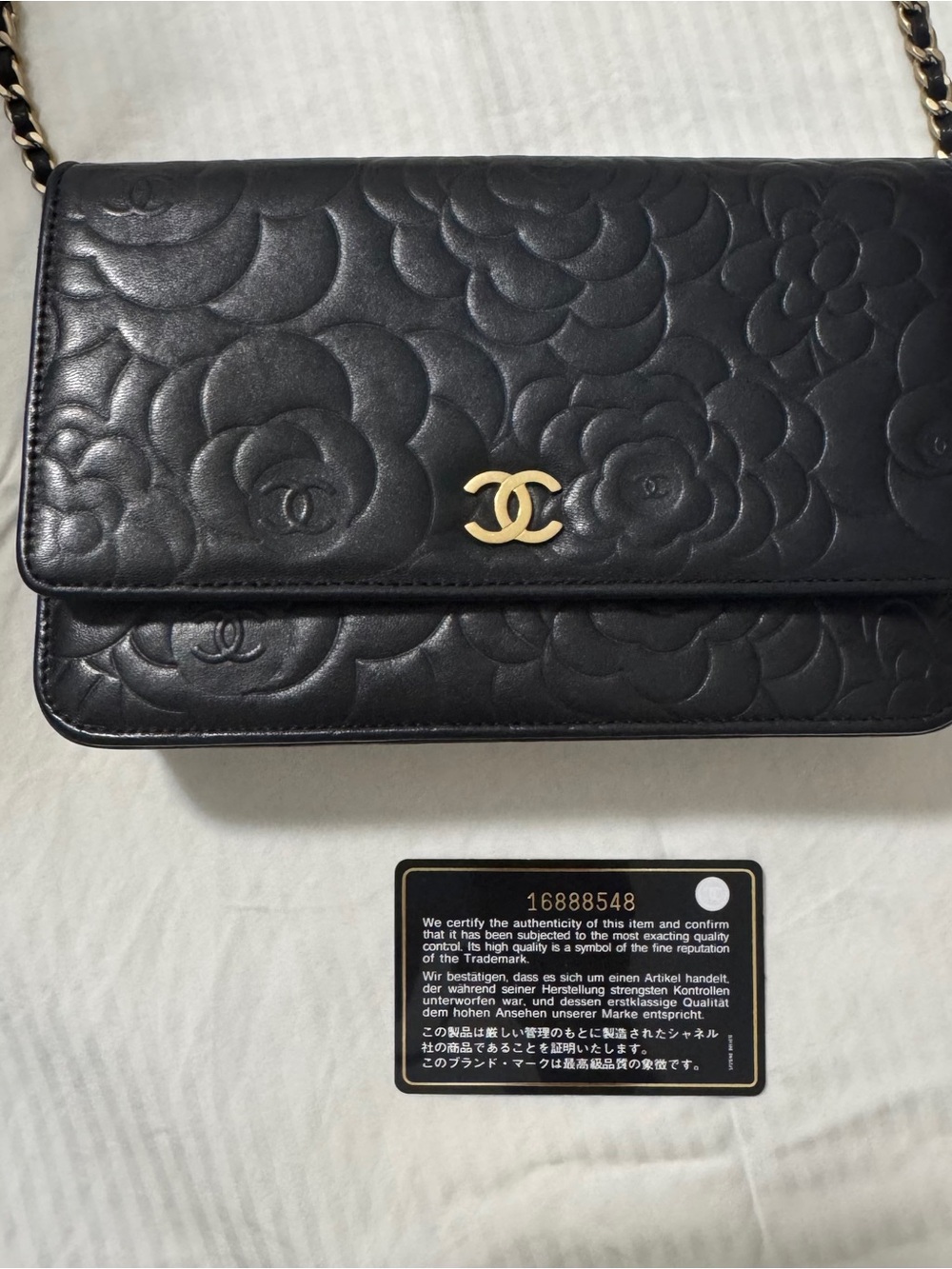 CHANEL Black WOC  . Quilted Camellia Leather Crossbody with Gold CC Hardware.